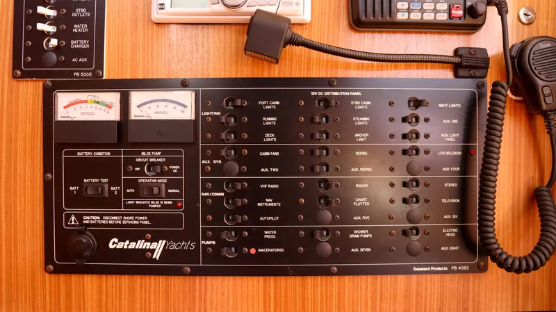 Slide: The Image of Control panel of a 2010 Catalina 375 yacht with various switches and meters. - 11