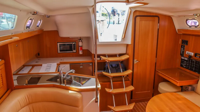 Slide: The Image of Interior of 2010 Catalina 375 sailboat with kitchen, stairs, and dining area. - 12