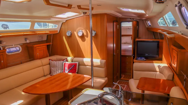 Slide: The Image of Interior of 2010 Catalina 375 sailboat with wood finish and cozy seating area. - 13