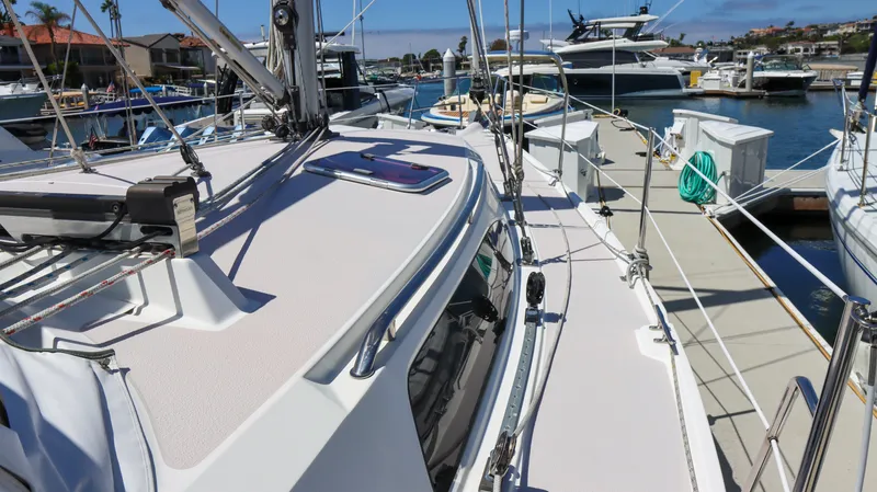 Slide: The Image of 2010 Catalina 375 sailboat docked at marina, showcasing deck and rigging. - 5