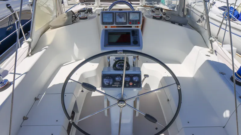 Slide: The Image of Cockpit of a 2010 Catalina 375 sailboat with navigation instruments and steering wheel. - 6