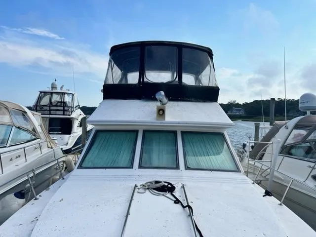 Slide: The Image of 1990 Sea Ray 380 Aft Cabin yacht docked at a marina. - 1