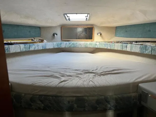 Slide: The Image of 1990 Sea Ray 380 Aft Cabin bedroom with large bed and skylight. - 12