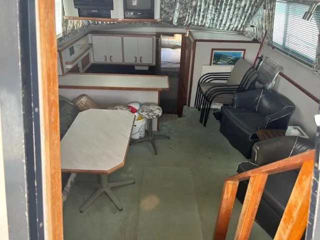 Slide: The Image of Interior of 1990 Sea Ray 380 Aft Cabin with seating area and kitchenette. - 19