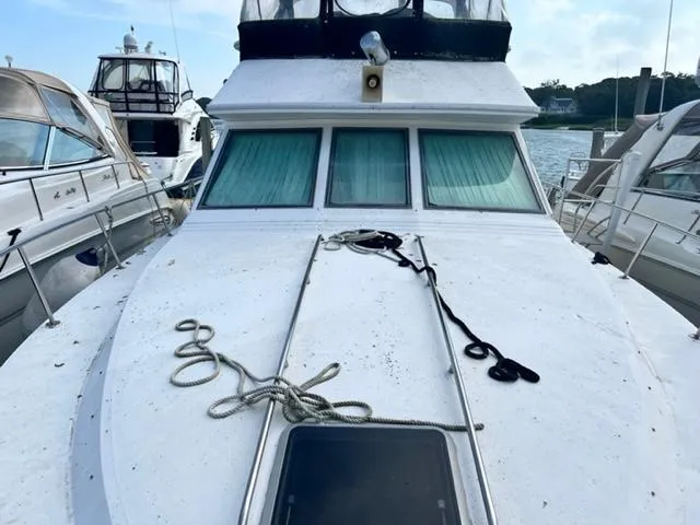 Slide: The Image of 1990 Sea Ray 380 Aft Cabin yacht docked at marina, front deck view. - 2