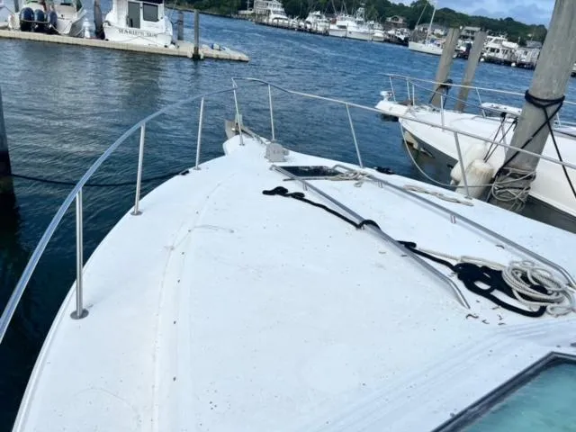 Slide: The Image of 1990 Sea Ray 380 Aft Cabin yacht docked at a marina. - 3