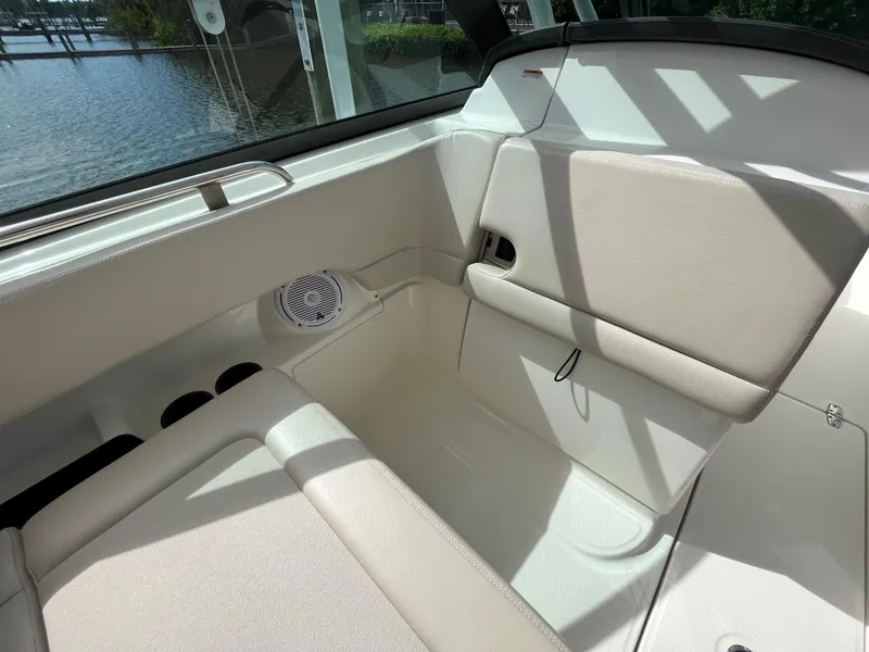 Slide: The Image of Interior seating of 2016 Boston Whaler 230 Vantage boat with beige upholstery. - 10