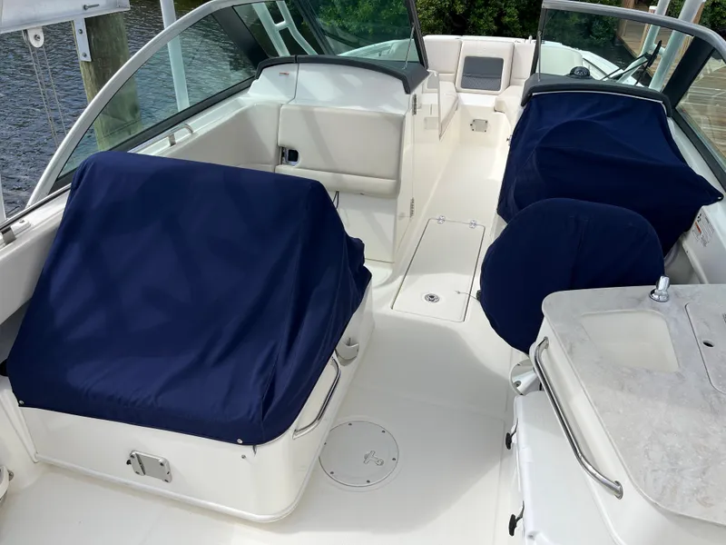 Slide: The Image of 2016 Boston Whaler 230 Vantage boat interior with blue seat covers. - 12
