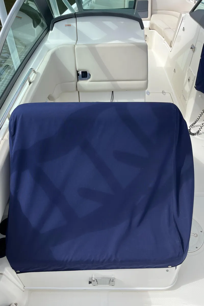 Slide: The Image of 2016 Boston Whaler 230 Vantage boat interior with blue seat cover. - 13