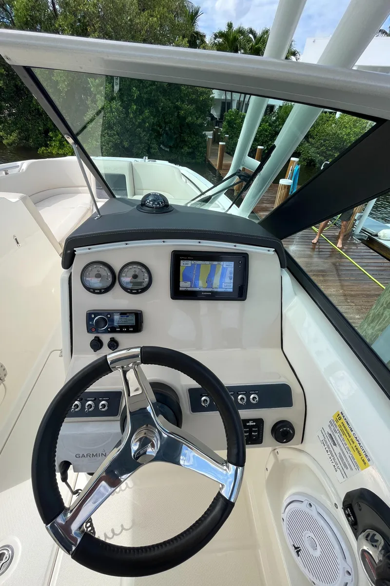 Slide: The Image of 2016 Boston Whaler 230 Vantage boat dashboard with steering wheel and navigation system. - 16