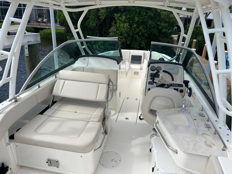 Slide: The Image of 2016 Boston Whaler 230 Vantage boat interior with seating and control console. - 2