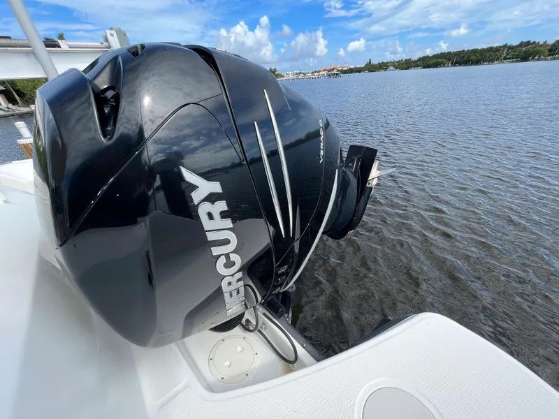 Slide: The Image of 2016 Boston Whaler 230 Vantage with Mercury outboard motor on a calm lake. - 22