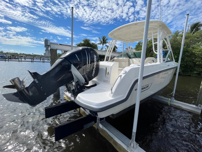 Slide: The Image of 2016 Boston Whaler 230 Vantage boat docked with Mercury outboard motor. - 24