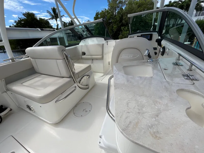 Slide: The Image of 2016 Boston Whaler 230 Vantage boat interior with seating and sink. - 5