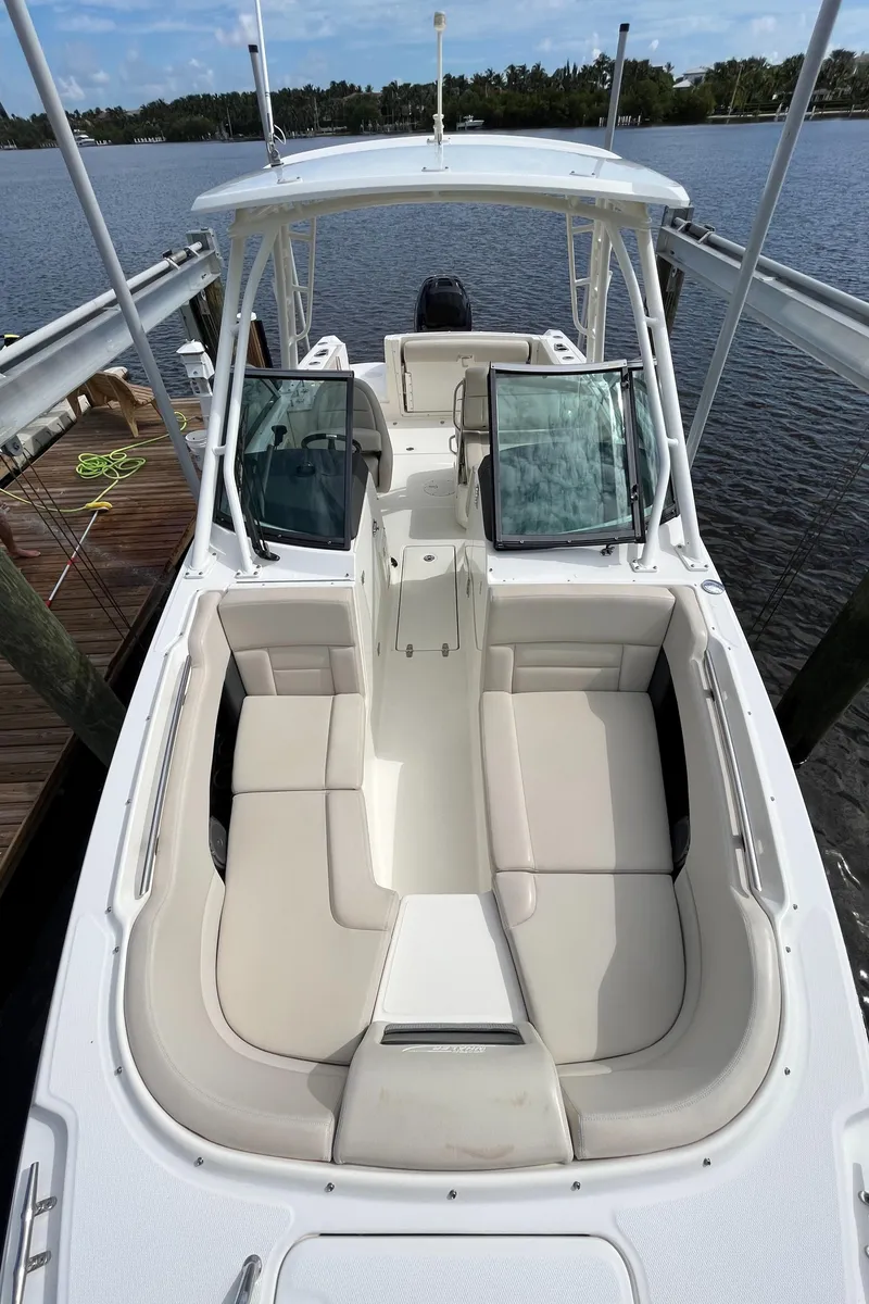 Slide: The Image of 2016 Boston Whaler 230 Vantage boat docked, featuring spacious seating and open deck. - 7