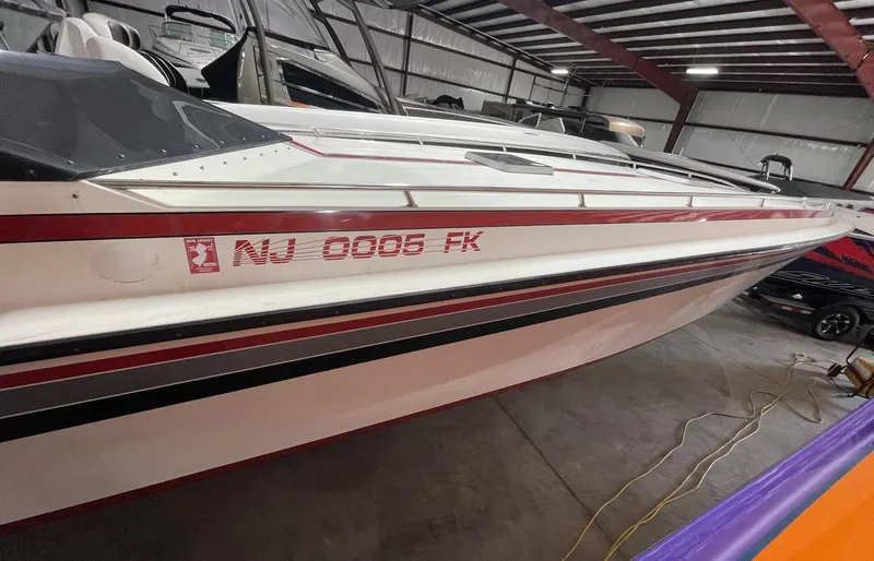 Slide: The Image of 1989 Fountain 12m speedboat in storage, side view with registration number NU 0005 FK. - 8