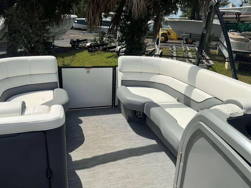 Slide: The Image of 2023 MONACO 235 DFL boat interior with white seating and spacious layout. - 13