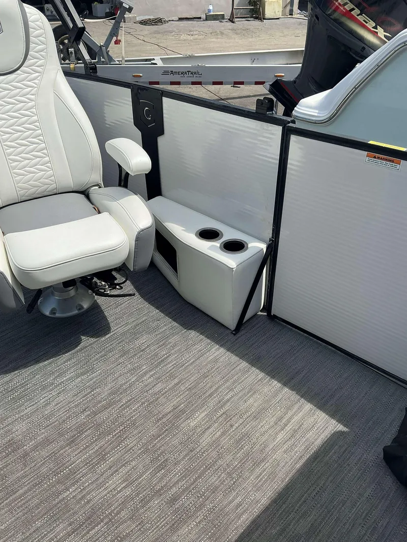 Slide: The Image of Luxurious interior of 2023 MONACO 235 DFL boat with plush seating and cup holders. - 8