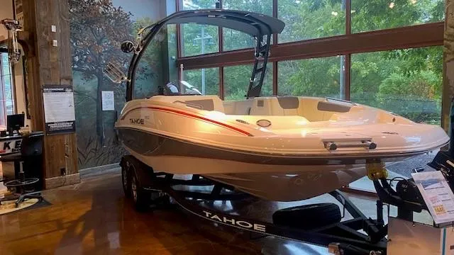 Slide: The Image of 2023 Tahoe 1950 boat on display indoors. - 2