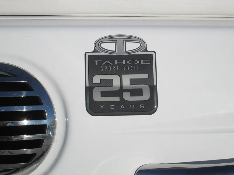 Slide: The Image of 2023 Tahoe 210 Si Limited 25th Anniversary Edition badge on white boat exterior. - 11