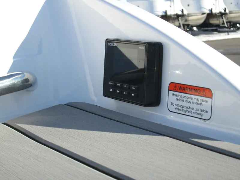 Slide: The Image of 2023 Tahoe 210 Si Limited boat dashboard with control panel and warning label. - 12