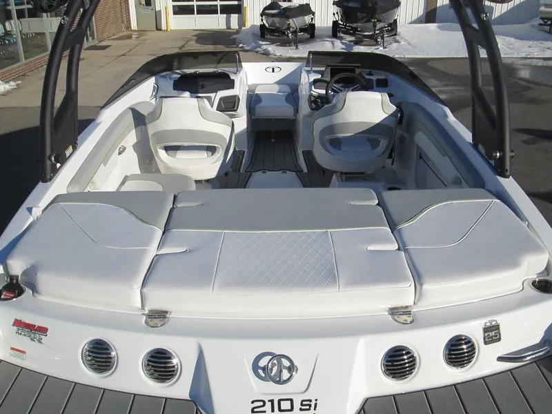 Slide: The Image of 2023 Tahoe 210 Si Limited boat interior with white seating and modern design. - 18