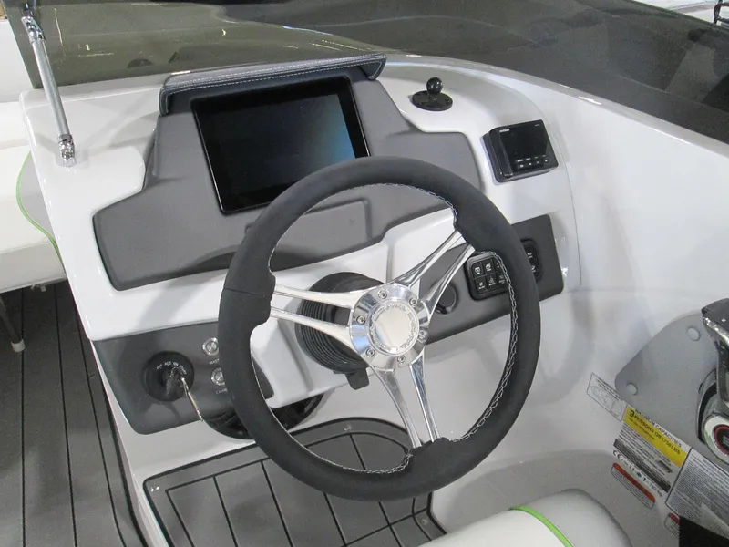 Slide: The Image of 2023 Tahoe 210 Si Limited boat dashboard with steering wheel and touchscreen display. - 22