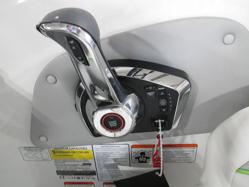 Slide: The Image of 2023 Tahoe 210 Si Limited boat throttle control and ignition switch. - 25