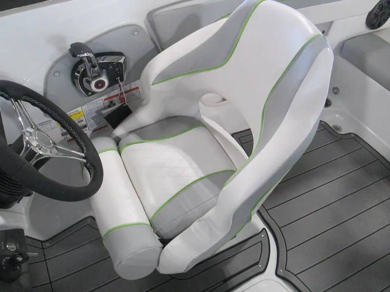 Slide: The Image of 2023 Tahoe 210 Si Limited boat cockpit with white and gray captain's chair. - 27