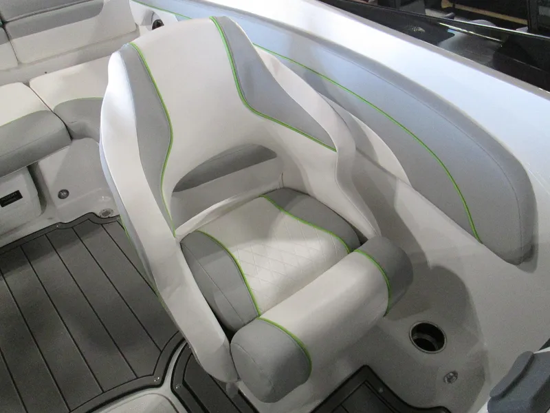 Slide: The Image of 2023 Tahoe 210 Si Limited boat seat with gray and white upholstery and green accents. - 28