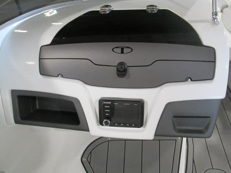 Slide: The Image of 2023 Tahoe 210 Si Limited boat dashboard with storage compartments and control panel. - 29