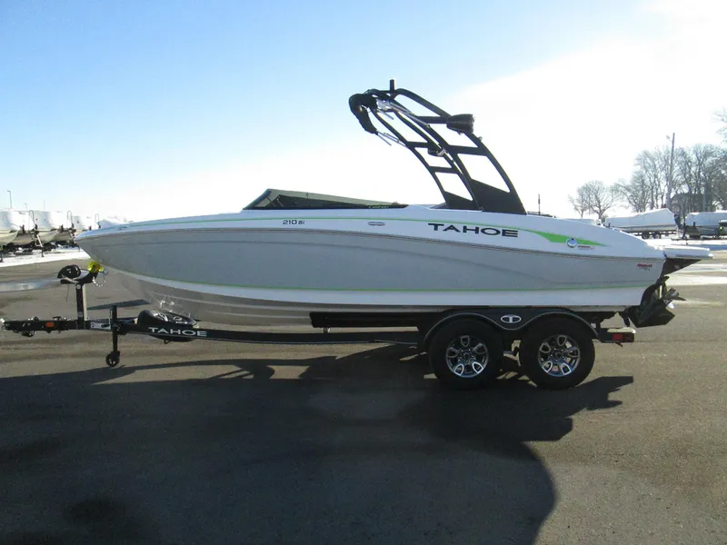 Slide: The Image of 2023 Tahoe 210 Si Limited boat on trailer in outdoor setting. - 3