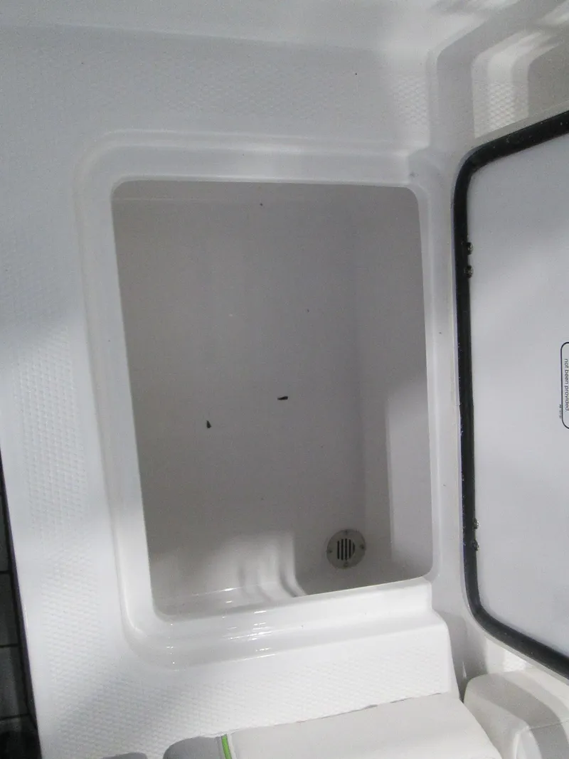 Slide: The Image of 2023 Tahoe 210 Si Limited boat storage compartment. - 34