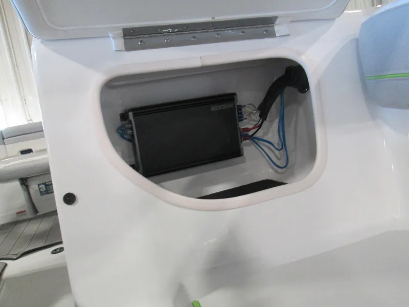 Slide: The Image of 2023 Tahoe 210 Si Limited boat storage compartment with electrical components. - 42