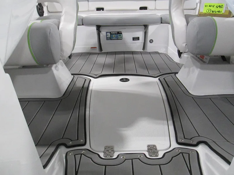 Slide: The Image of 2023 Tahoe 210 Si Limited boat interior with gray flooring and cushioned seating. - 44