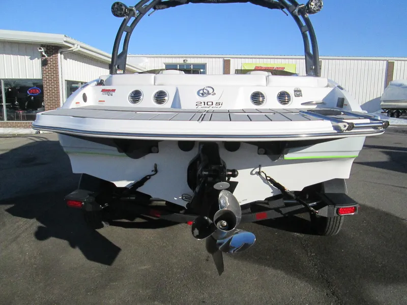 Slide: The Image of 2023 Tahoe 210 Si Limited boat rear view with propeller and trailer. - 5