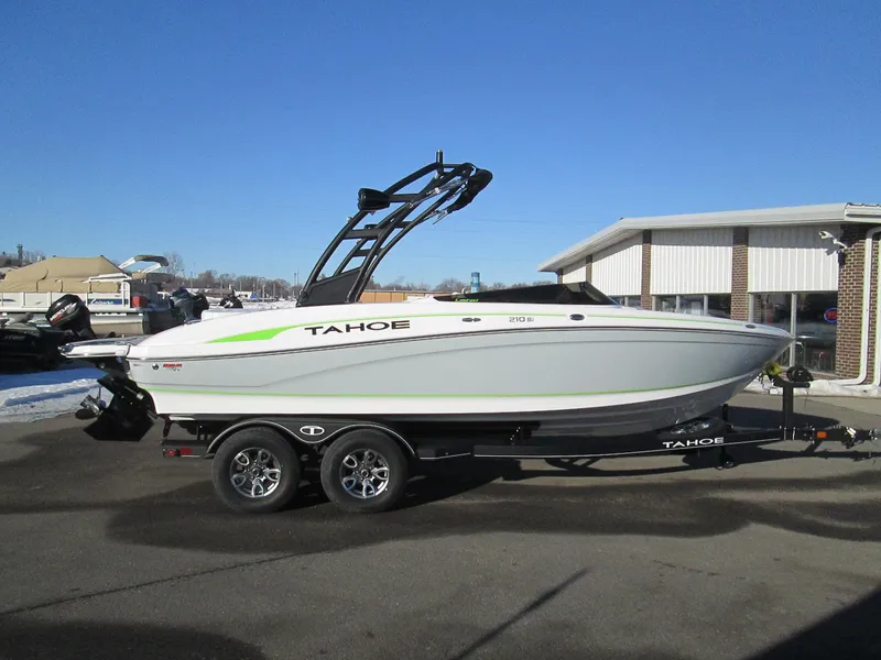 Slide: The Image of 2023 Tahoe 210 Si Limited boat on a trailer in a parking lot. - 7