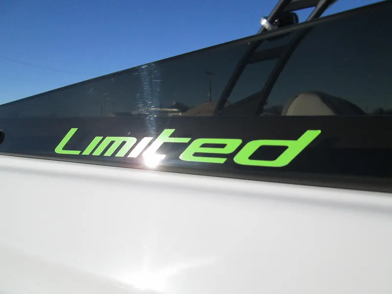 Slide: The Image of 2023 Tahoe 210 Si Limited boat with green Limited decal. - 9