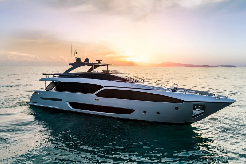 Slide: The Image of 2024 Riva 90' Argo yacht cruising at sunset on the open sea. - 2