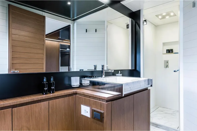 Slide: The Image of Luxurious bathroom on the 2024 Riva 90' Argo yacht with modern fixtures and wooden cabinetry. - 20