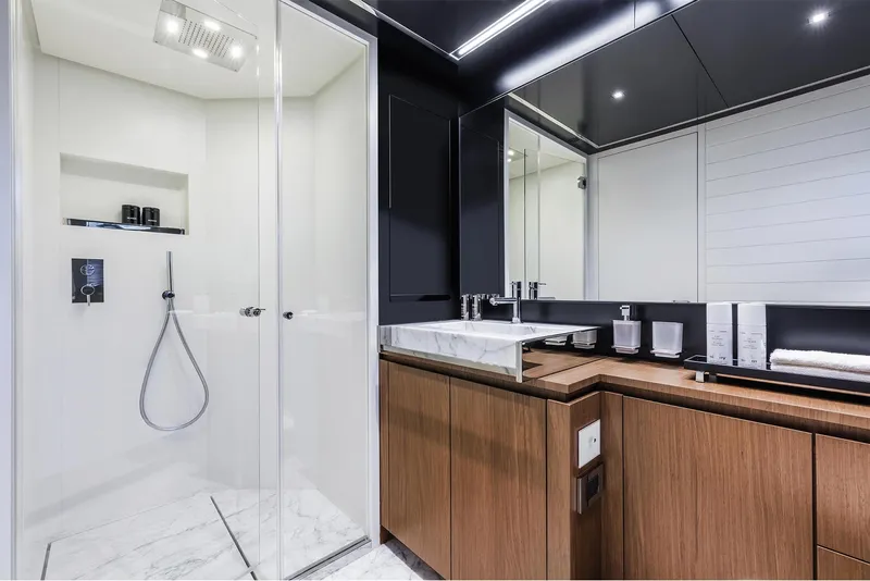 Slide: The Image of Modern bathroom on the 2024 Riva 90' Argo yacht with sleek shower and marble sink. - 21
