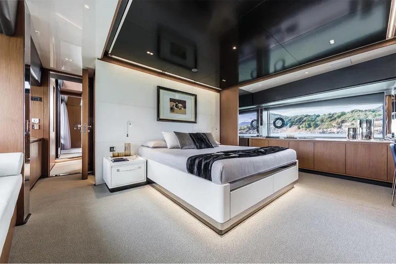 Slide: The Image of Luxurious bedroom interior of 2024 Riva 90' Argo yacht with modern design and scenic window view. - 23