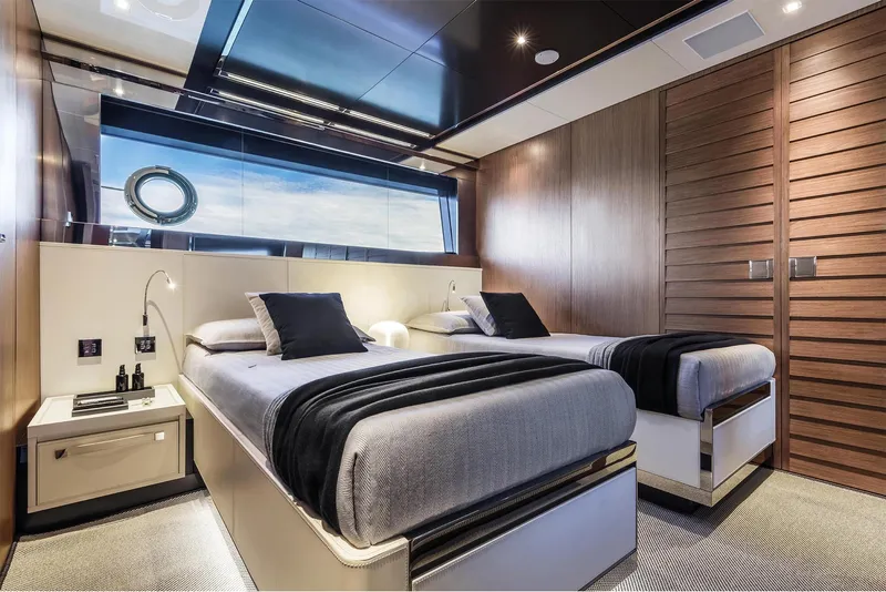 Slide: The Image of Luxurious twin bedroom on the 2024 Riva 90' Argo yacht with modern decor. - 24