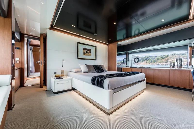 Slide: The Image of Luxurious bedroom interior of 2024 Riva 90' Argo yacht with modern design and scenic window view. - 26