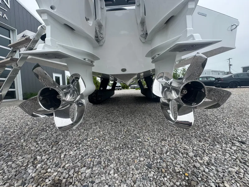 Slide: The Image of 2023 Iguana Sport boat with dual propellers on gravel surface. - 11