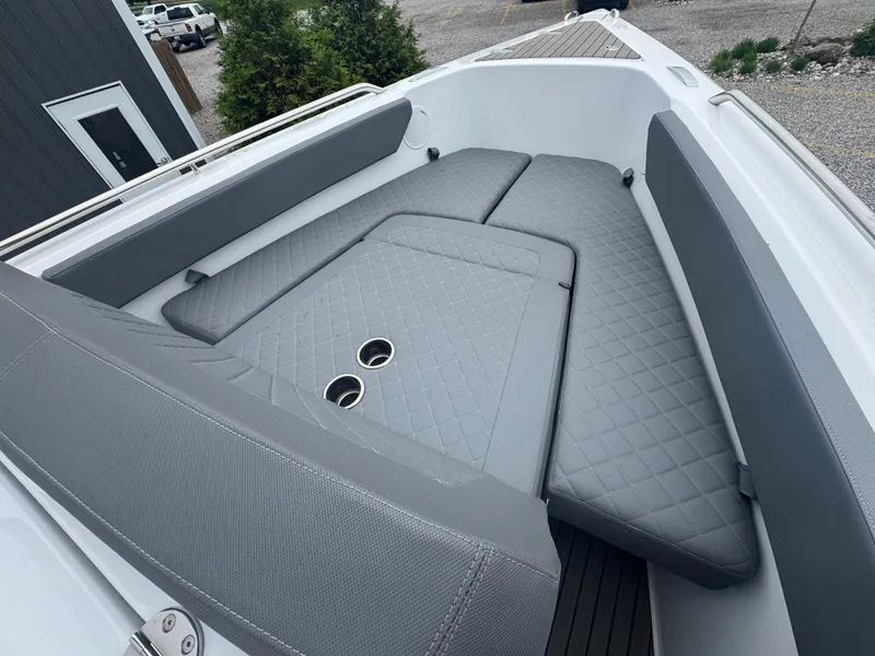 Slide: The Image of 2023 Iguana Sport boat interior with gray cushioned seating and cup holders. - 15