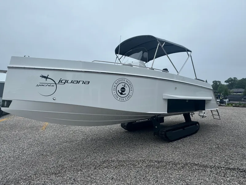 Slide: The Image of 2023 Iguana Sport amphibious boat on gravel, featuring retractable tracks and canopy. - 7