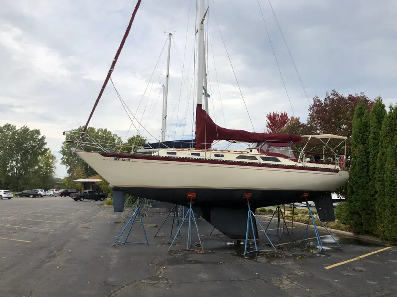 Slide: The Image of 1977 Islander 36 sailboat on stands in a parking lot. - 14