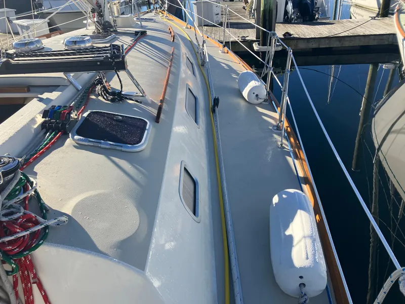 Slide: The Image of 1989 Pearson 39-2 sailboat deck with ropes and fenders at a marina. - 14