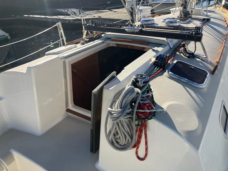 Slide: The Image of 1989 Pearson 39-2 sailboat deck with ropes and open hatch in marina. - 15